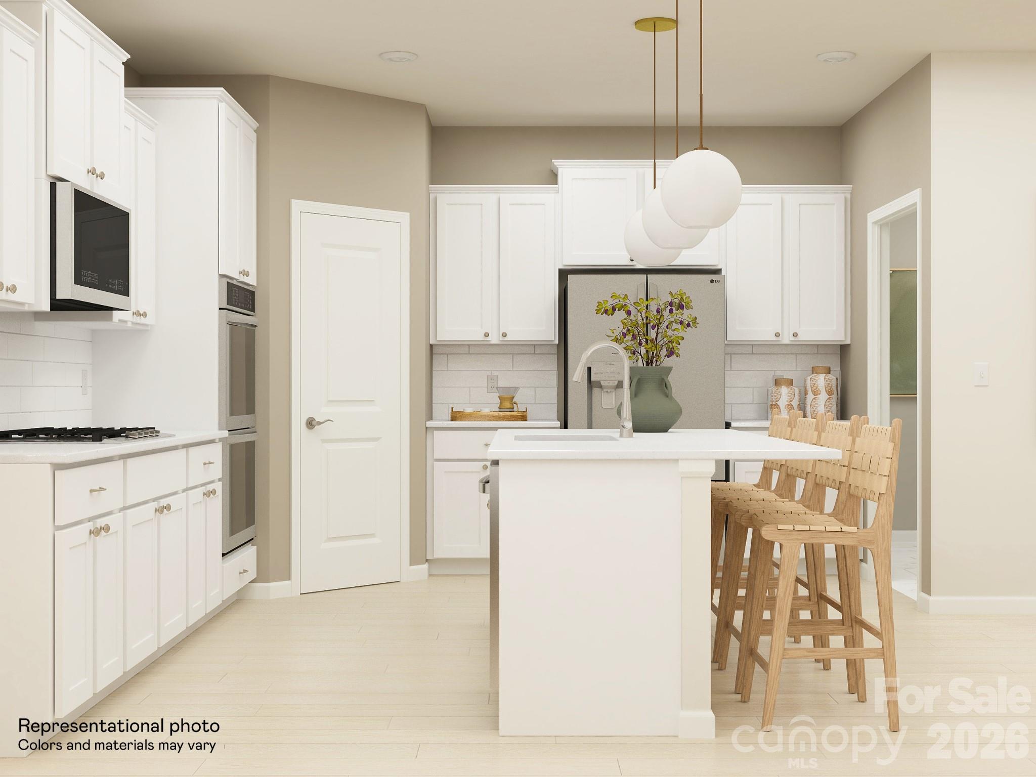 5451 Redbud Road, Unit 52 Lancaster, SC 29720 - Photo 2 of 22 a kitchen with kitchen island white cabinets and white appliances