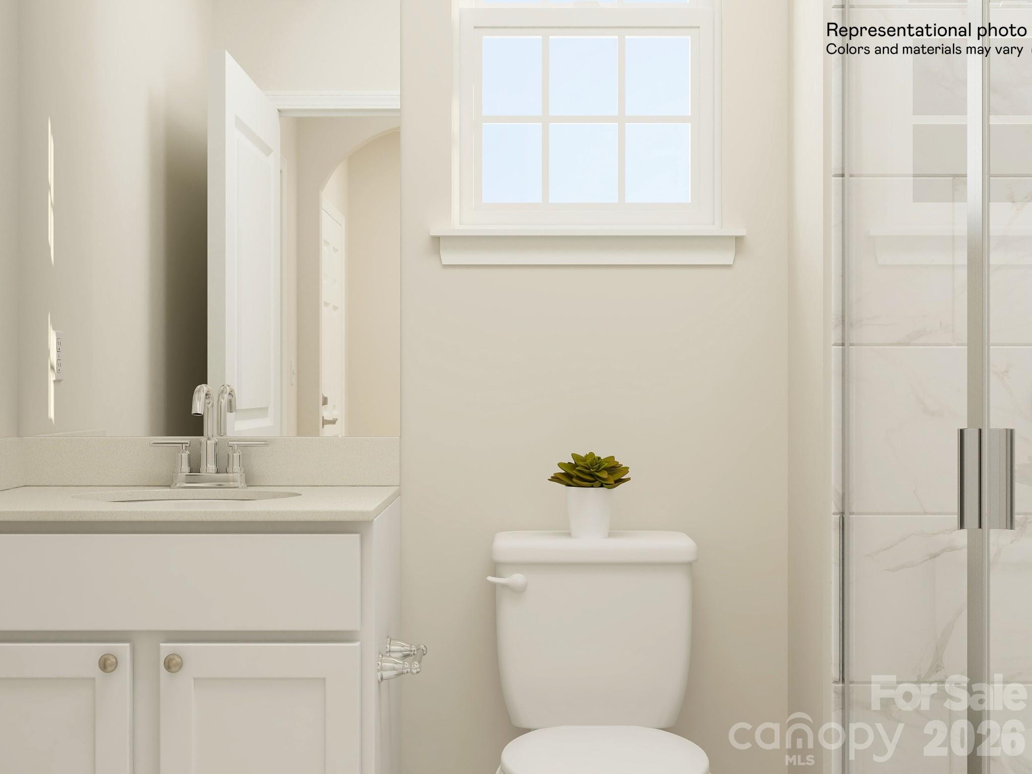 5451 Redbud Road, Unit 52 Lancaster, SC 29720 - Photo 8 of 22 a bathroom with a toilet sink and mirror