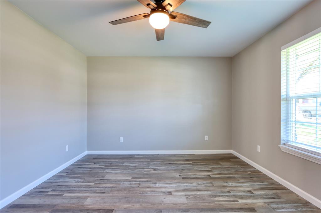 111 Kay Drive Robinson, TX 76706 - Photo 17 of 40 a view of an empty room with window and wooden floor