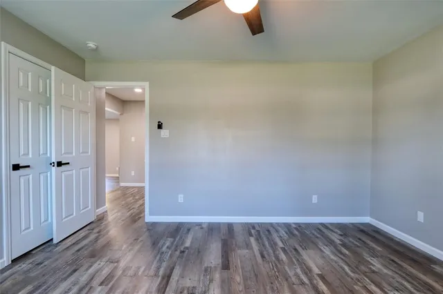 a view of an empty room and wooden floor