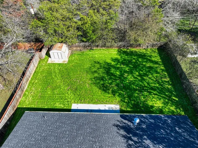 a view of a yard with large trees