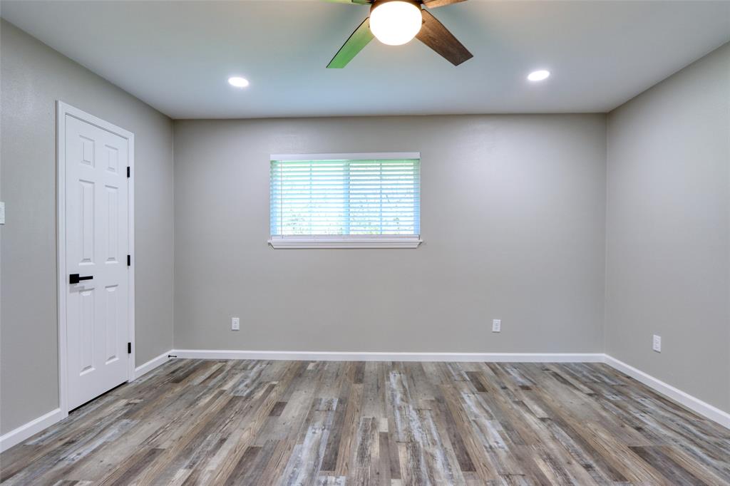 111 Kay Drive Robinson, TX 76706 - Photo 10 of 40 an empty room with wooden floor and windows