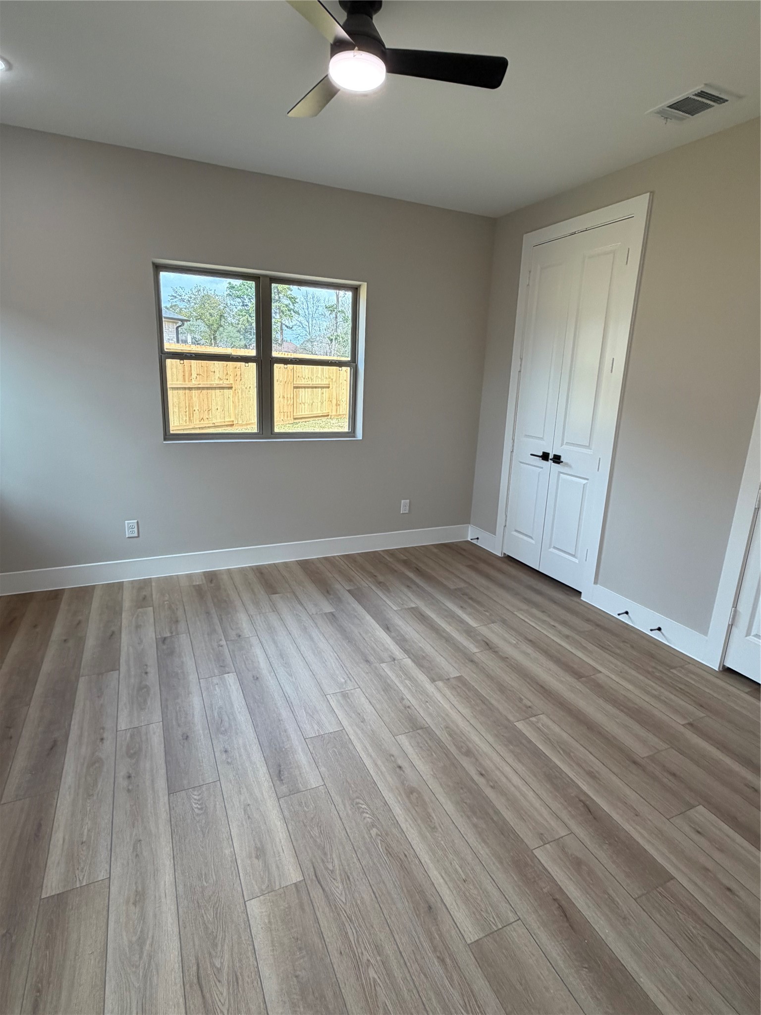 2514 Liguria Lane Spring, TX 77388 - Photo 11 of 25 wooden floor in an empty room with a window
