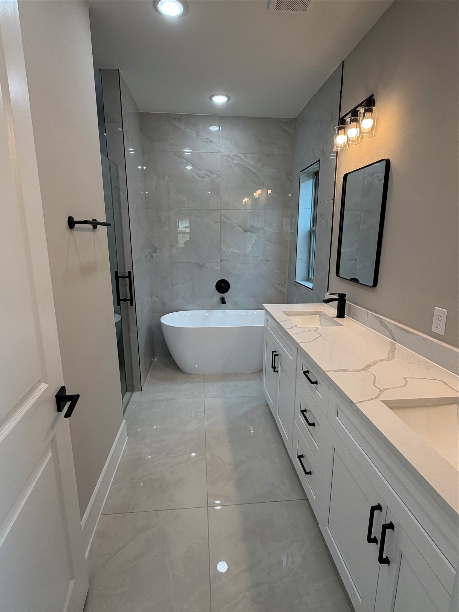 2514 Liguria Lane Spring, TX 77388 - Photo 13 of 25 a bathroom with a double vanity sink a mirror and a shower