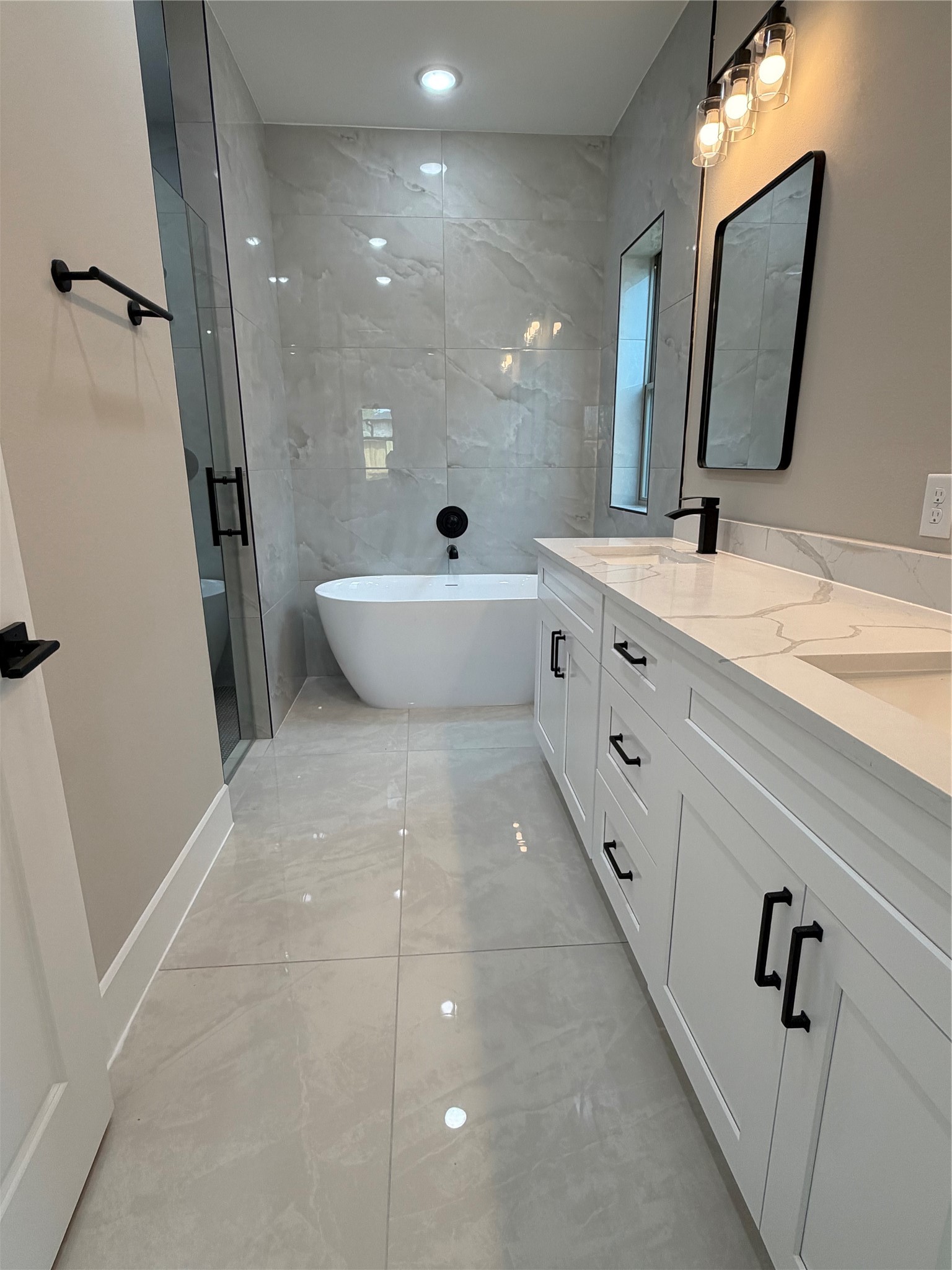 2514 Liguria Lane Spring, TX 77388 - Photo 18 of 25 a bathroom with a double vanity sink a mirror and a bathtub