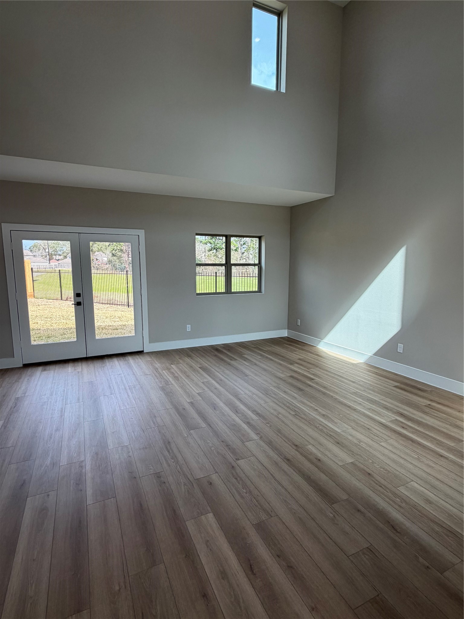 2514 Liguria Lane Spring, TX 77388 - Photo 4 of 25 an empty room with wooden floor and windows