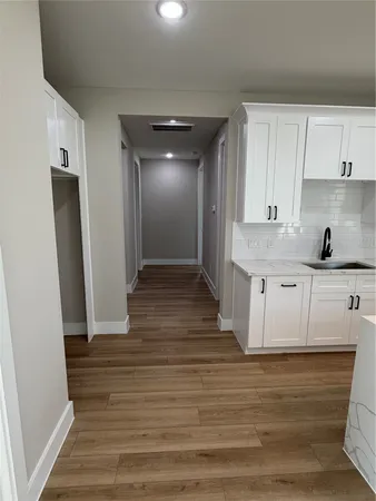 a view of a kitchen from the hallway