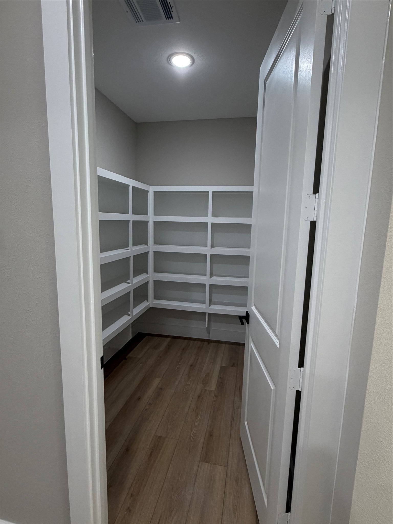 2514 Liguria Lane Spring, TX 77388 - Photo 10 of 25 a view of walk in closet with wooden floor and cabinet