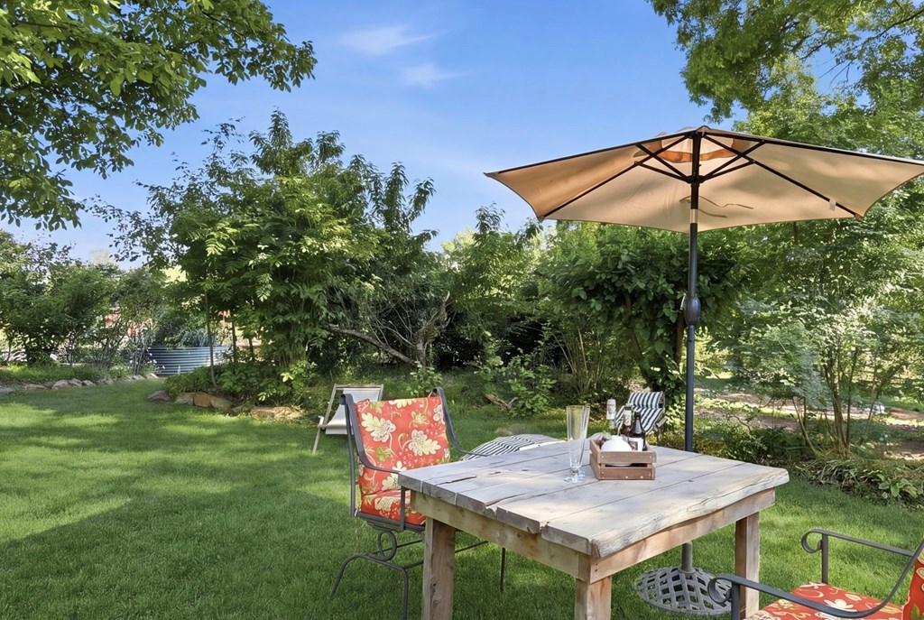 1823 Shoal Creek Road Clarkesville, GA 30523 - Photo 124 of 149 a backyard of a house with table and chairs