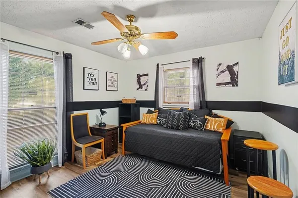 a living room with furniture a rug and a window