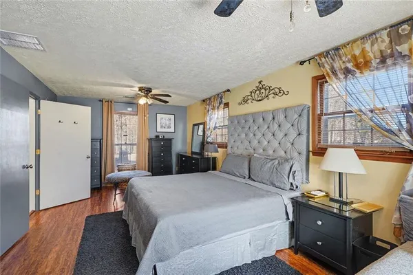 a bedroom with a bed and a night stand on a dresser