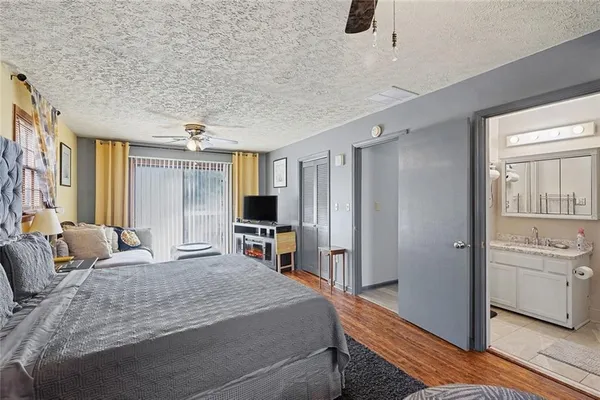 a bedroom with a bed a window and dresser