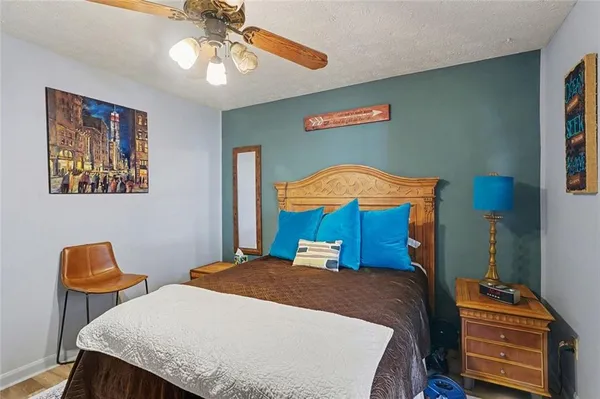 a bedroom with a bed and a chandelier