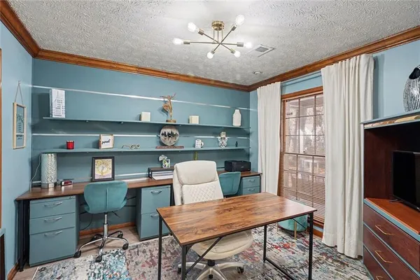 a view of a dining room with furniture and a chandelier