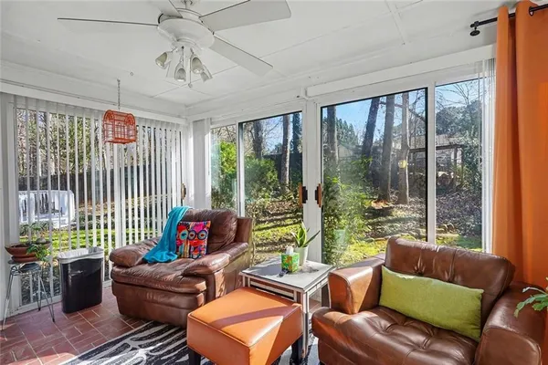 a living room with furniture and a floor to ceiling window