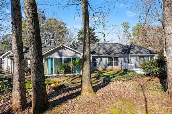 a view of a house with backyard and sitting area