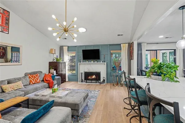 a living room with furniture fireplace and a flat screen tv