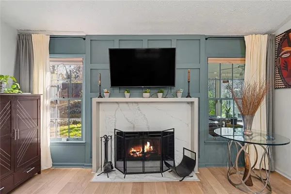 a living room with a fireplace a flat screen tv and a fireplace
