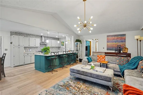 a living room with furniture and kitchen view