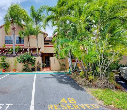 a front view of a house with a tree