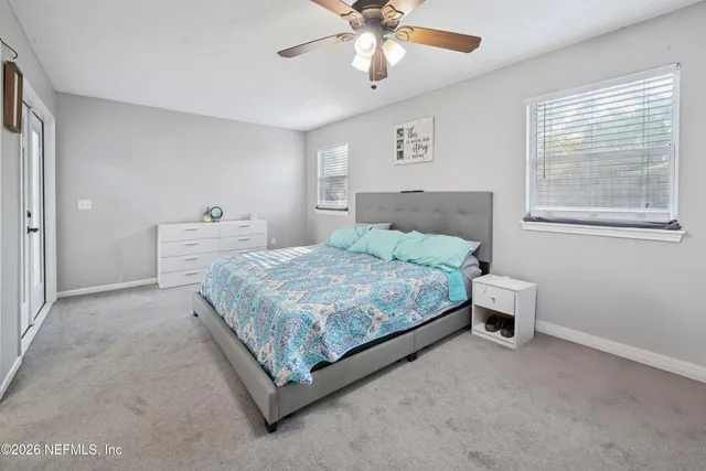 a bedroom with a bed and window