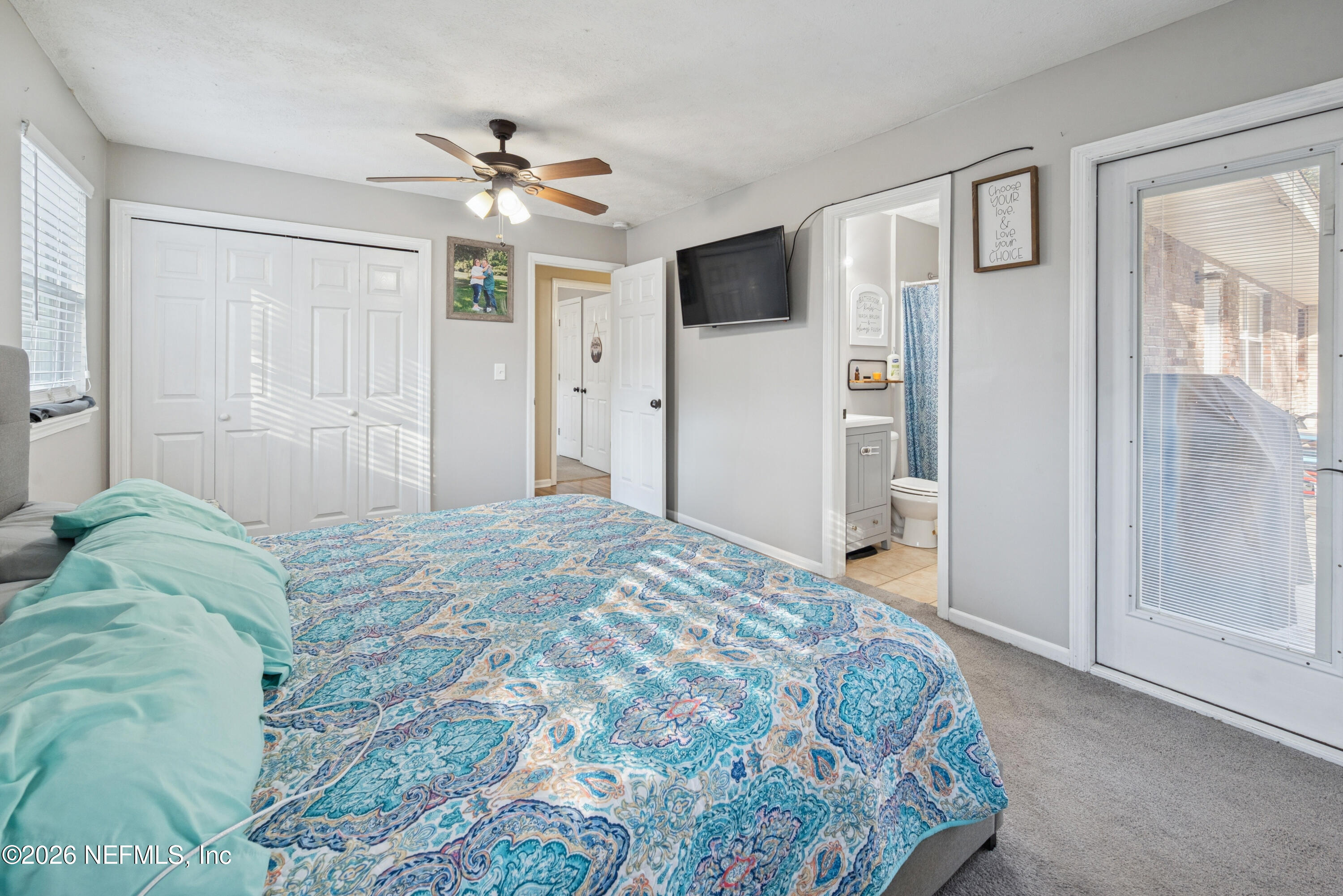 240 Highway 16 Starke, FL 32091 - Photo 15 of 32 a bedroom with a large bed and a chandelier
