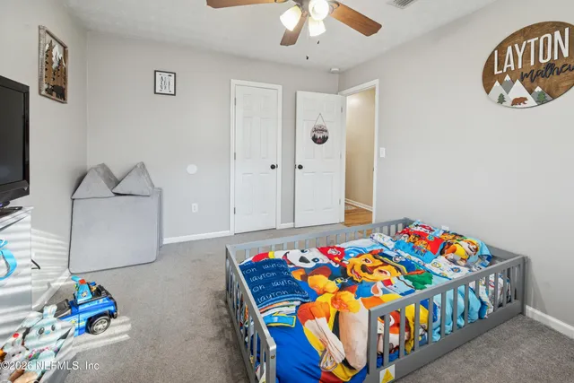 a bedroom with bed and a chandelier