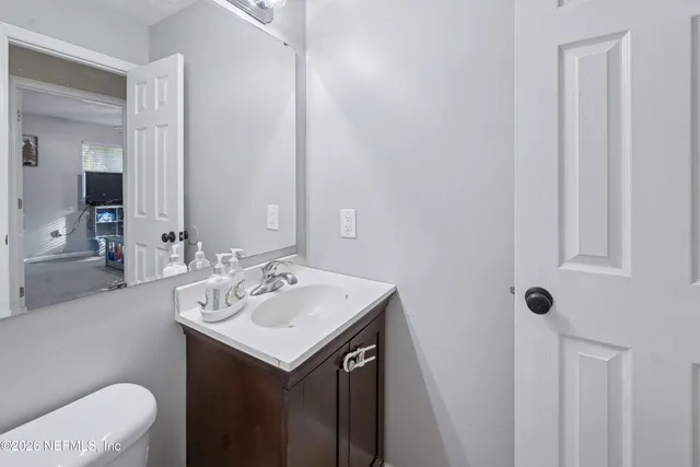 a bathroom with a sink toilet and mirror