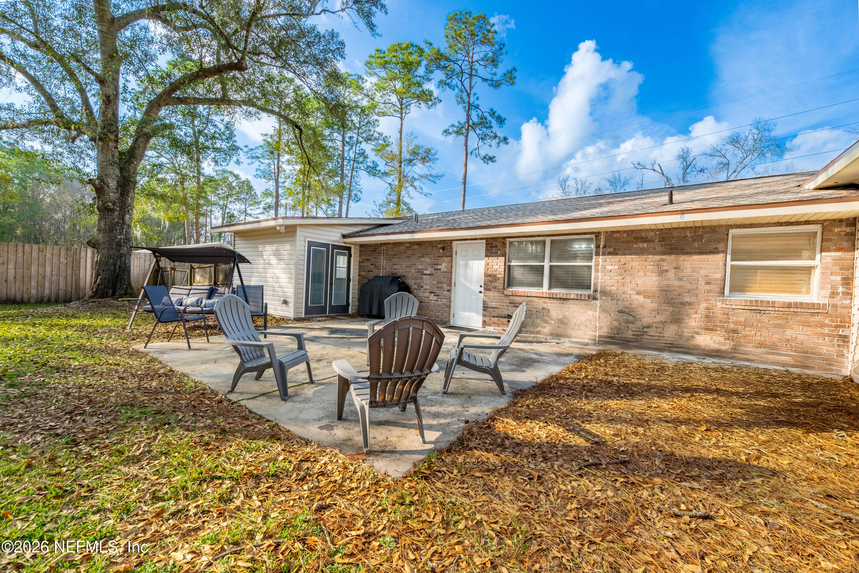 240 Highway 16 Starke, FL 32091 - Photo 29 of 32 a view of a patio with table and chairs near a large tree