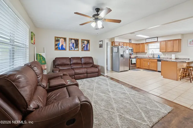 a living room with furniture and kitchen view