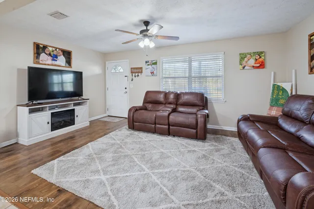 a living room with furniture and a flat screen tv