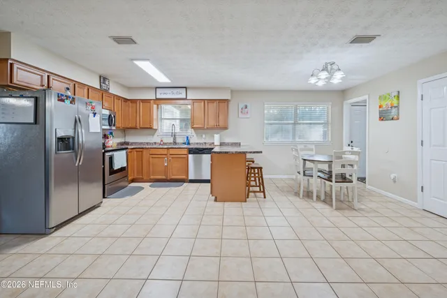 a kitchen with stainless steel appliances a refrigerator sink and cabinets