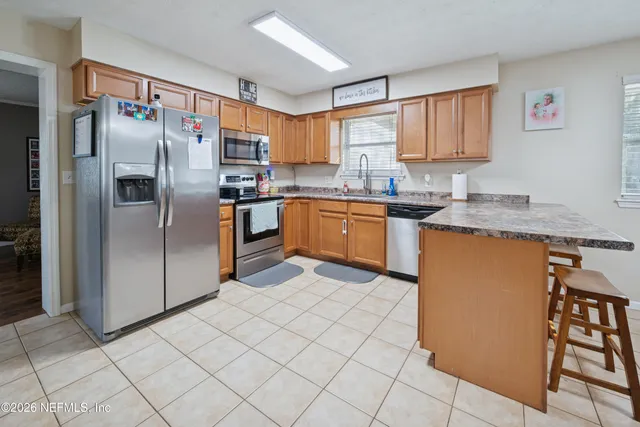 a kitchen with stainless steel appliances granite countertop a refrigerator sink and cabinets