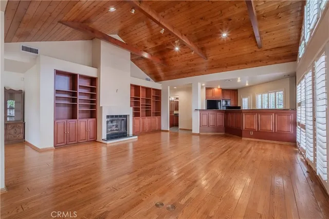 a view of a livingroom with furniture wooden floor and windows