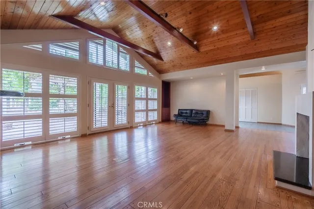 a hallway with wooden floor and furniture