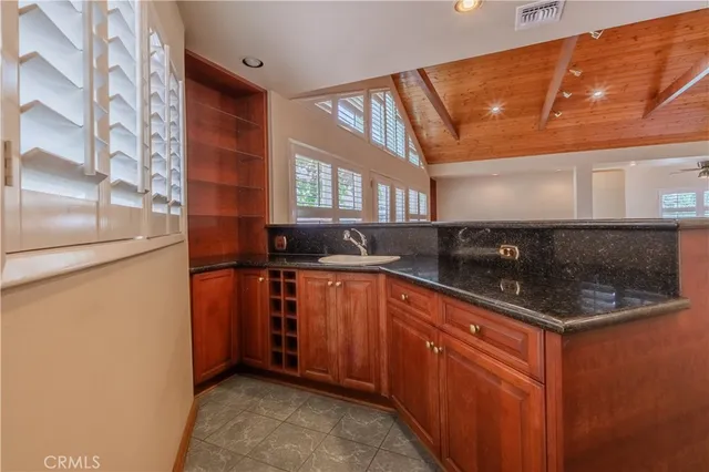 a kitchen with stainless steel appliances granite countertop a sink stove and cabinets