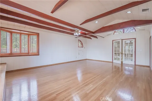 wooden floor in an empty room with a window