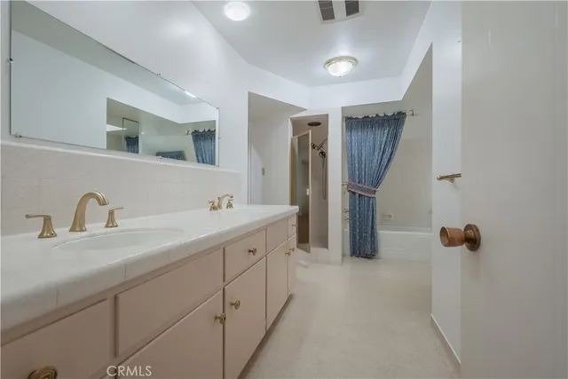 a bathroom with double sink and mirror