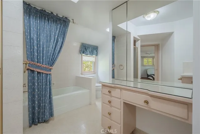 a bathroom with a sink a mirror and a bathtub