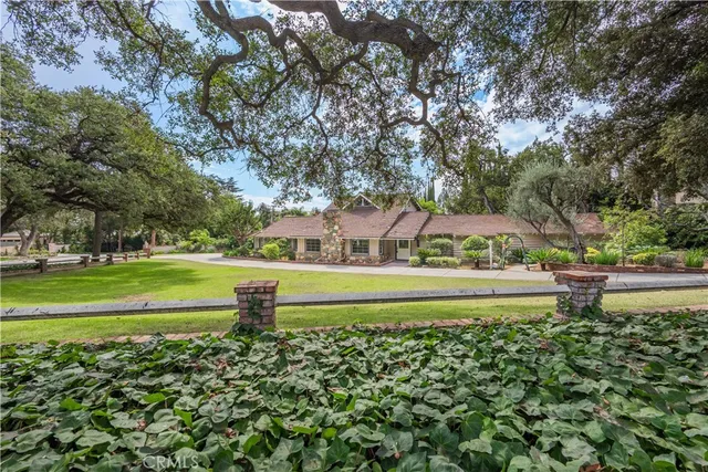 a view of building with garden and trees