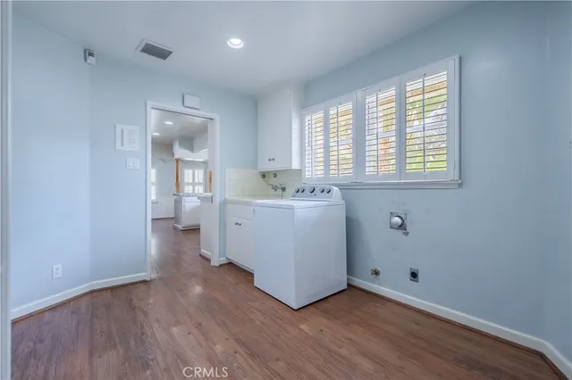 a view of a room with wooden floor and sink