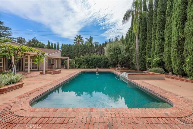 a swimming pool with outdoor seating and yard