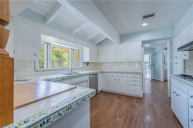 a kitchen with a stove a sink and a refrigerator