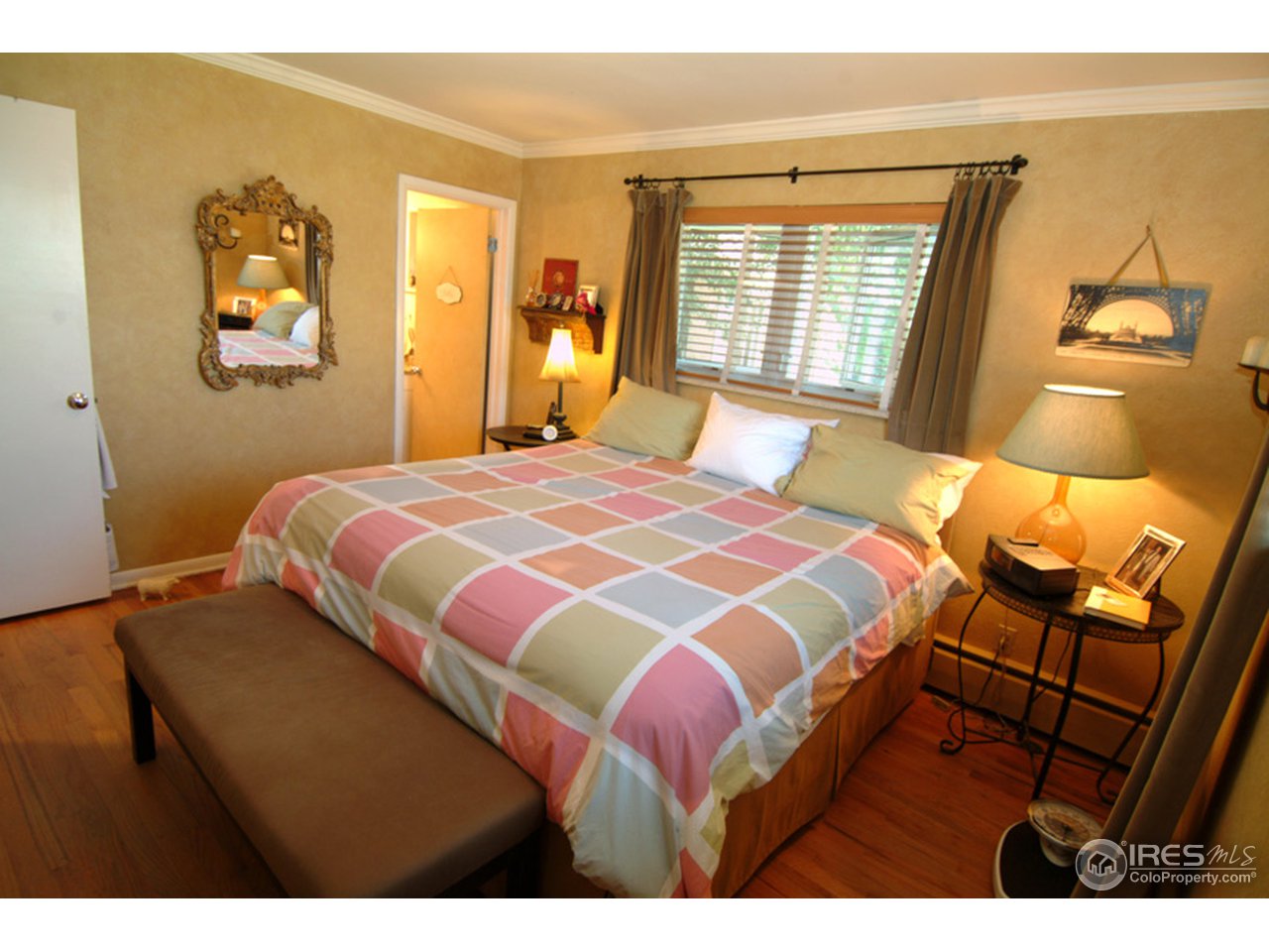 248 Ridge Road Boulder, CO 80303 - Photo 10 of 18 a bedroom with a bed and wooden floor