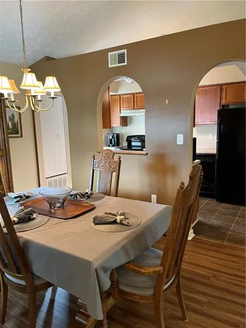 a kitchen with stainless steel appliances a sink a stove a refrigerator a sink a counter space and cabinets