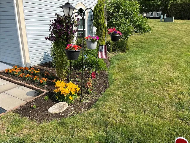 a living room with furniture ceiling fan and a window