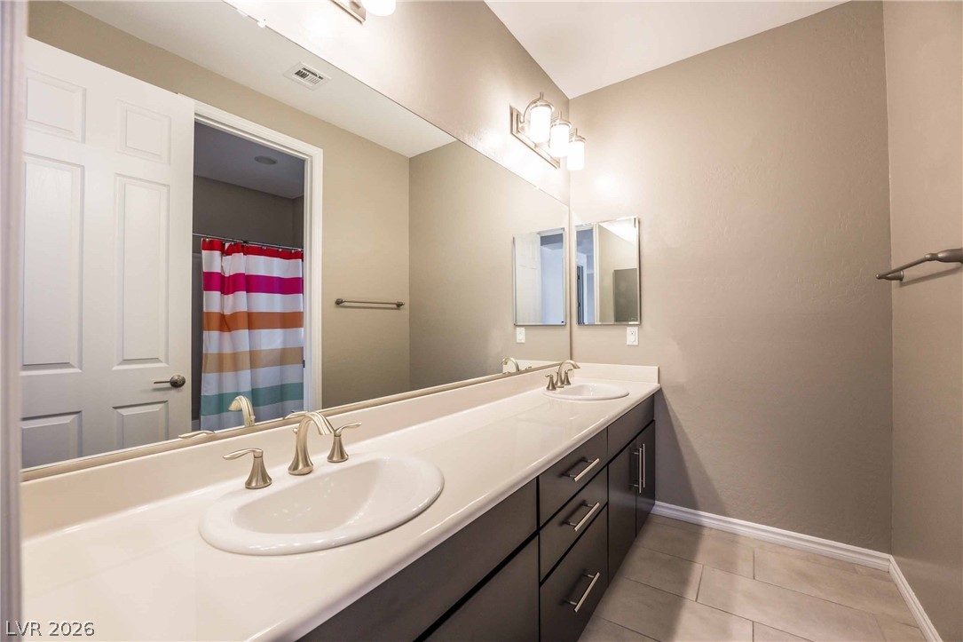 2787 Athens Ridge Drive Henderson, NV 89052 - Photo 23 of 31 Double vanities and contemporary fixtures adorn this well-appointed bathroom.