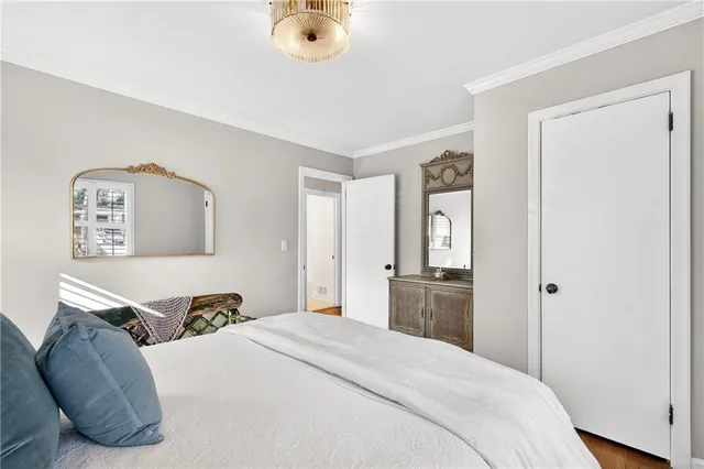 a bedroom with a bed and painting on the wall