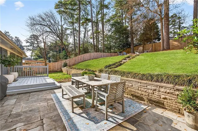 a view of backyard with seating area and green space