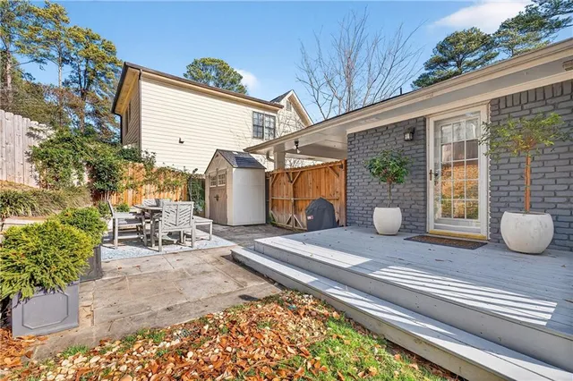 a view of a patio with table and chairs and potted plants